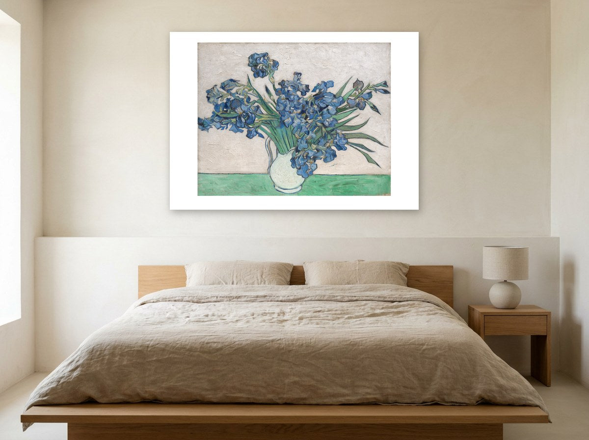 Mise en situation : affiche Les Iris au mur crème d'une chambre claire, au-dessus d'un lit au linge de lin beige